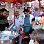 Volunteers serving drinks (Sabeel) to the mourners during the Ashura procession on 9th Muharram-ul-Harram at Nori Gate