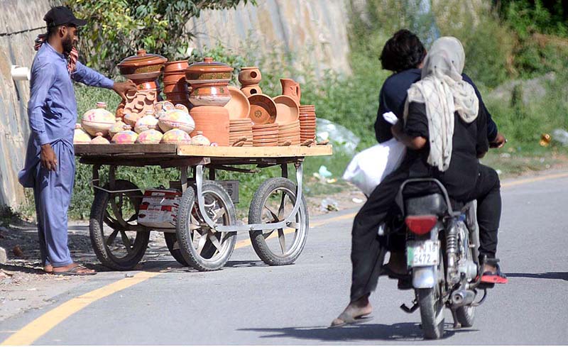 Gypsy woman collecting valuables from dustbin at G9 weekly Bazaar