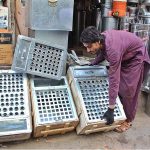 Shopkeeper setting up frames of Kulfi to attract customers at Mission Road