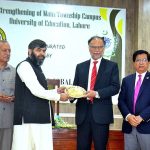 Federal Minister for Planning and Development and Special Initiatives Prof. Ahsan Iqbal University of Education College is presenting a souvenir to the members of the project