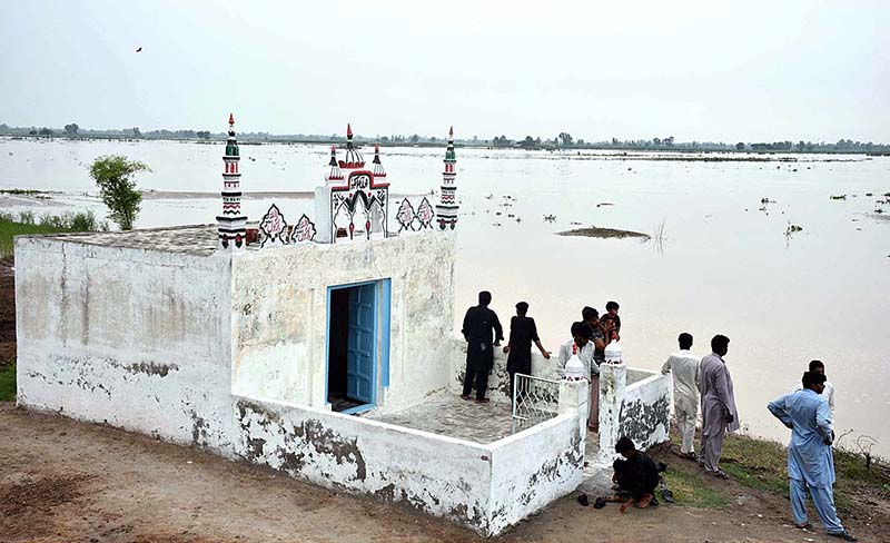 People cross flood water on a boat after river Ravi water entered in their houses at Village Naul Manga Mandi 30 Kilometer from the Provincial Capital
