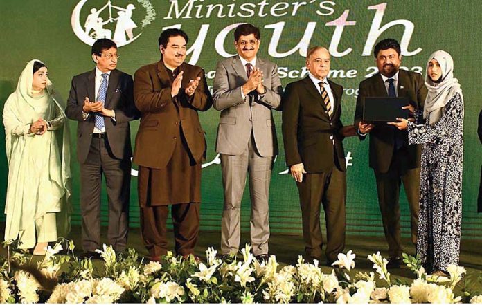 Prime Minister Muhammad Shehbaz Sharif distributing laptops among high achievers of public sector university students under the Prime Minister's Youth Laptop Scheme at the Sindh Governor House