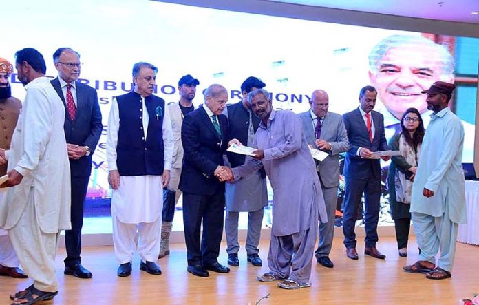 Prime Minister Muhammad Shehbaz Sharif distributes cheques among the fishermen of Gwadar