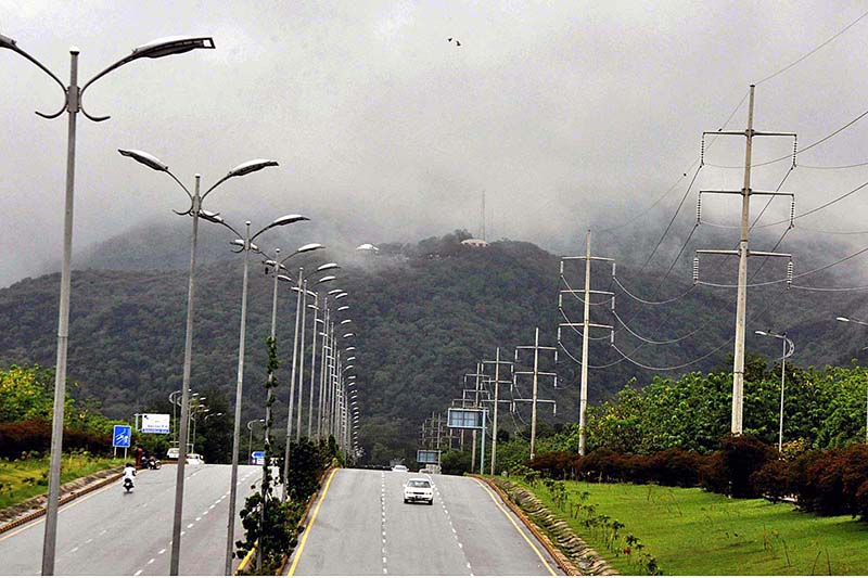 A view of clouds hovering over the Margalla Hills during rain in Federal Capital