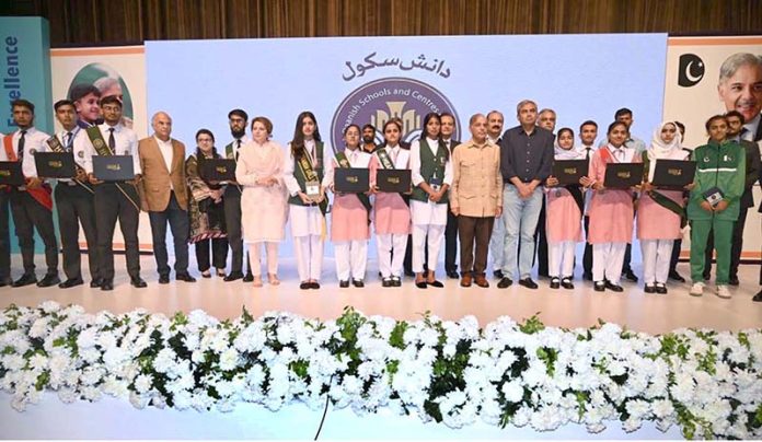 Prime Minister Muhammad Shehbaz Sharif in a group photo with high-achievers of Danish schools on the ceremony of merit-based distribution of laptops among high-achievers under the Prime Minister’s Laptop initiative