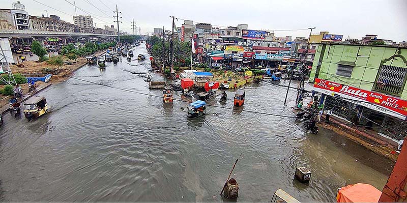 Vehicles passing through rainwater accumulated on road after heavy rain in Provincial Capital
