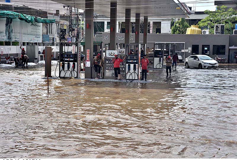 Vehicles passing through rain water accumulated on the road near Kalma Chowk during rain that experienced in the city