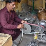 A skilled worker manufacturing export quality surgical instruments at his work place