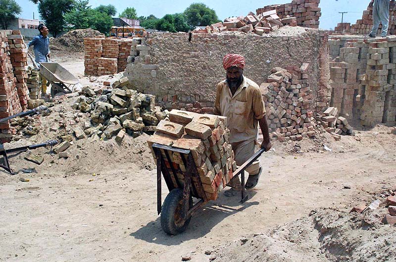 Labourers busy in preparing bricks at local bricks Kiln in Division