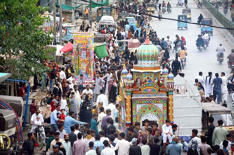 Devotees participate in the Tazia procession of Ashura on the 10th Muharram. Ashoura is the commemoration marking the Shahadat (death) of Hussein (AS), the grandson of the Prophet Muhammad (PBUH), with his family members and some of his companions massacred in battle of Karbala for the upright of Islam