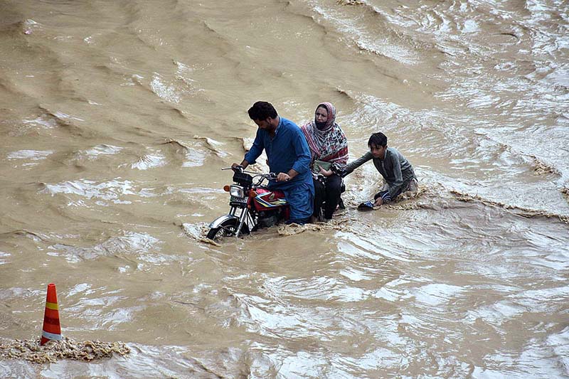 Vehicles passing through rain water accumulated on the Kalma Chowk underpass road during rain that experienced in the city
