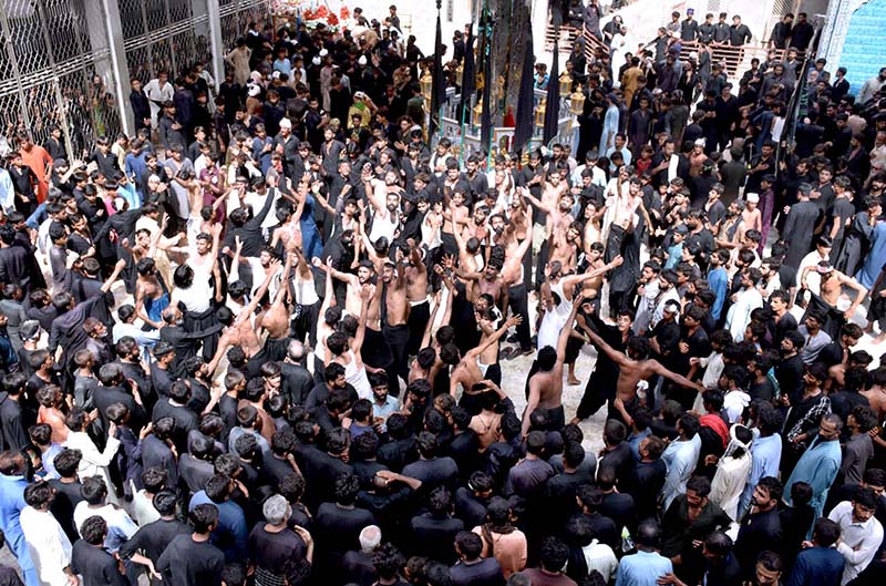 Mourners flagellate themselves with knifes on chains during the procession of Ashura on the 10th Muharram. Ashoura is the commemoration marking the Shahadat (death) of Hussein (AS), the grandson of the Prophet Muhammad (PBUH), with his family members and some of his companions massacred in battle of Karbala for the upright of Islam