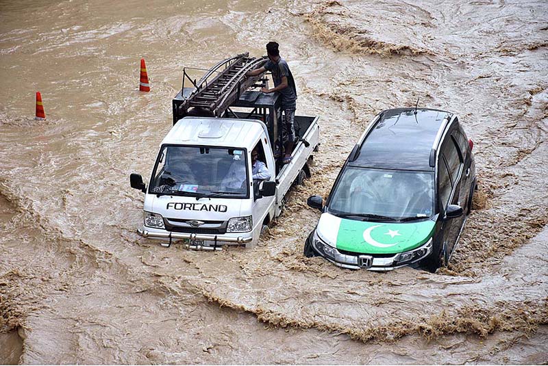 Vehicles passing through rain water accumulated on the Kalma Chowk underpass road during rain that experienced in the city