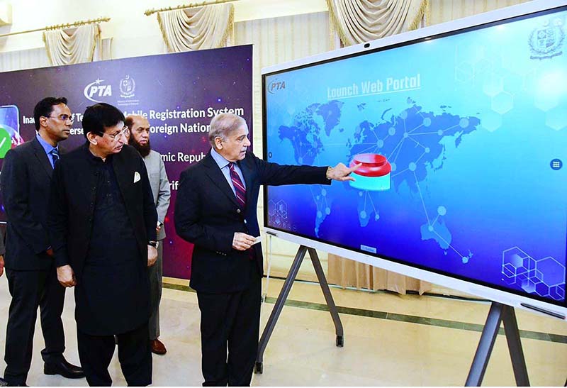 Prime Minister Muhammad Shehbaz Sharif pushing a button to inaugurate temporary Mobile Registration System for overseas Pakistanis & Foreign Nationals