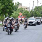 Security personnel conducting flag march regarding maintain law and order during Muharram