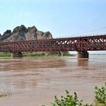 A view of railway train crossing from Railway Bridge during Medium level flood in River Chenab crossing 162246 cusses water