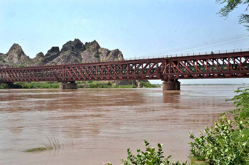 A view of railway train crossing from Railway Bridge during Medium level flood in River Chenab crossing 162246 cusses water