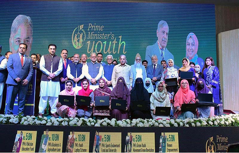 Prime Minister Muhammad Shehbaz Sharif in a group photo with high achievers who received laptops under the PM’s Youth Scheme distribution ceremony