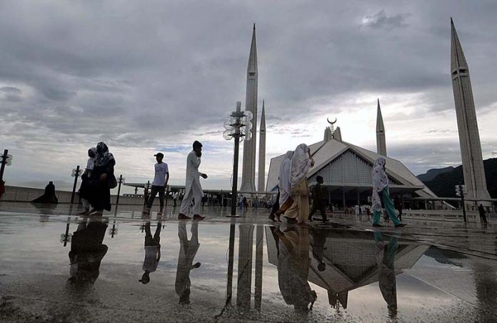 People visiting Shah Faisal Masjid in a pleasant weather after heavy rain that experienced at morning time in the city