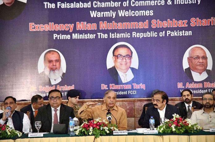 Prime Minister Muhammad Shehbaz Sharif addresses the members of the Faisalabad Chamber of Commerce and Industries
