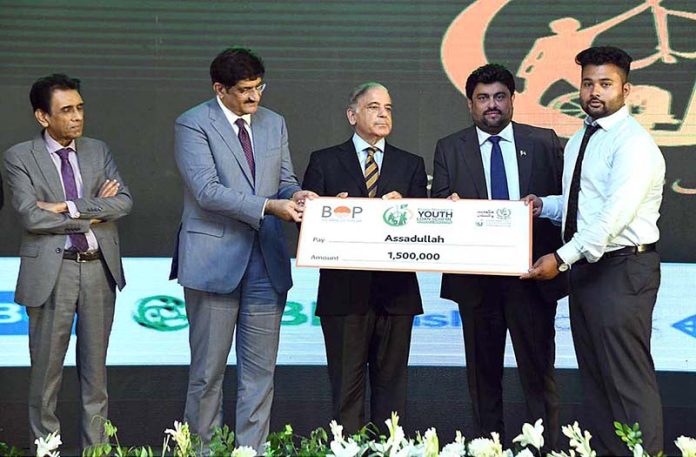 Prime Minister Muhammad Shehbaz Sharif distributing cheques among the successful candidates under PM's Youth Business Loan Scheme at Governor House