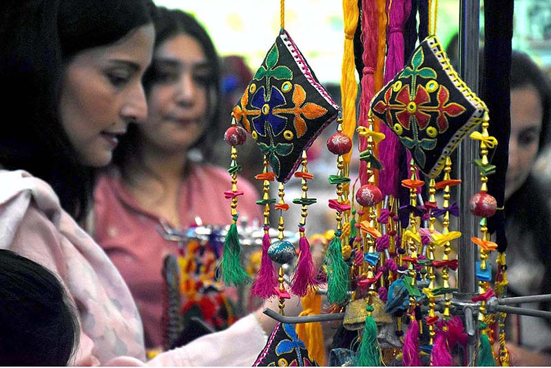 Visitors looking at handmade stuff during Dastkaar Mela organized by Punjab Small Industries in cooperation with Government of the Punjab “Pakistan Handicraft Shops Promoting Artisans and Handicrafts
