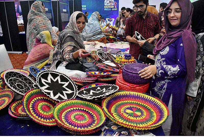 Visitors looking at handmade stuff during Dastkaar Mela organized by Punjab Small Industries in cooperation with Government of the Punjab “Pakistan Handicraft Shops Promoting Artisans and Handicrafts
