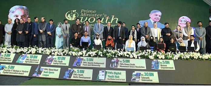 Prime Minister Muhammad Shehbaz Sharif in a group photo with high achievers who received laptops under PM's Youth Laptop Scheme 2023 at Governor House