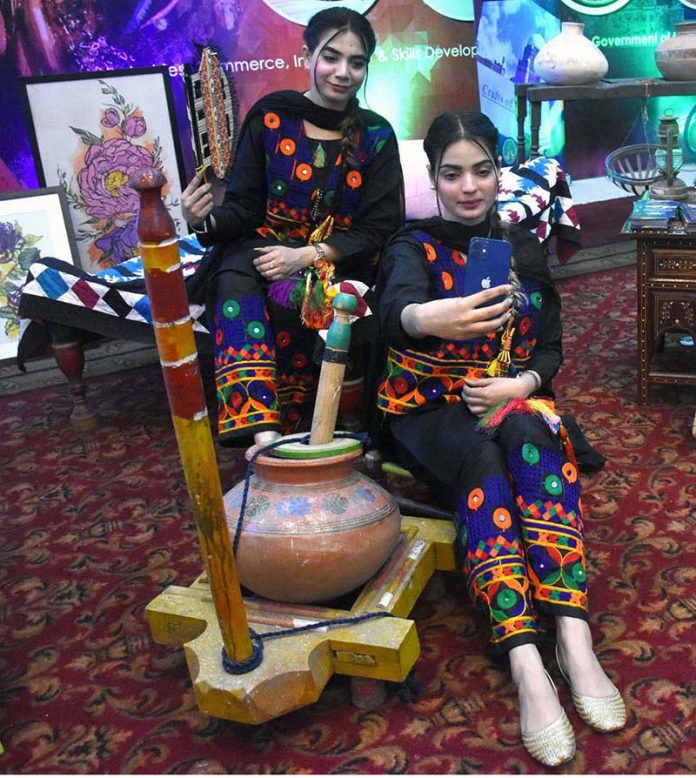Visitors taking selfie with handicrafts at Dastkaar Mela organized by Punjab Small Industries in cooperation with Government of the Punjab “Pakistan Handicraft Shops Promoting Artisans and Handicrafts