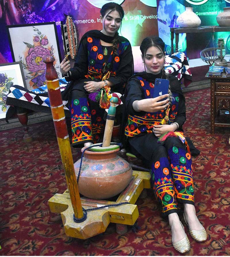 Visitors taking selfie with handicrafts at Dastkaar Mela organized by Punjab Small Industries in cooperation with Government of the Punjab “Pakistan Handicraft Shops Promoting Artisans and Handicrafts