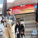 Security personal standing high alert in front of Imambargah