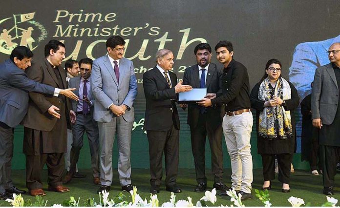 Prime Minister Muhammad Shehbaz Sharif distributes laptops among the high achievers of public sector universities of Sindh under PM's Youth Laptop Scheme 2023 at Governor House
