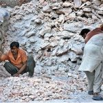 Labourers busy in crashing rocks of Pink salt into small pieces at their work place in Provincial Capital City