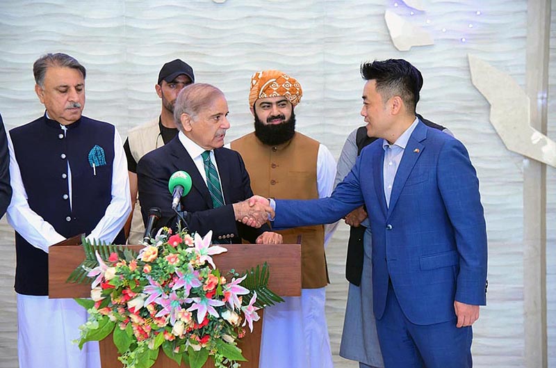 Prime Minister Muhammad Shehbaz Sharif interacts with a Chinese staff during his address to the media at Gwadar Business Center