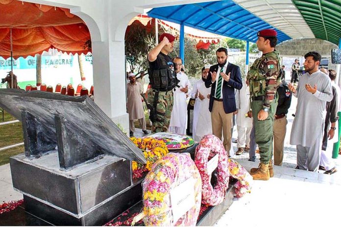 Special Assistant to the Prime Minister on Interior, Ataullah Tarar lays a floral wreath at the mausoleum of Captain Shaheed Colonel Sher Khan (Nishan-e-Haider) and offers Fateha on the occasion of his 24th Martyrdom Anniversary