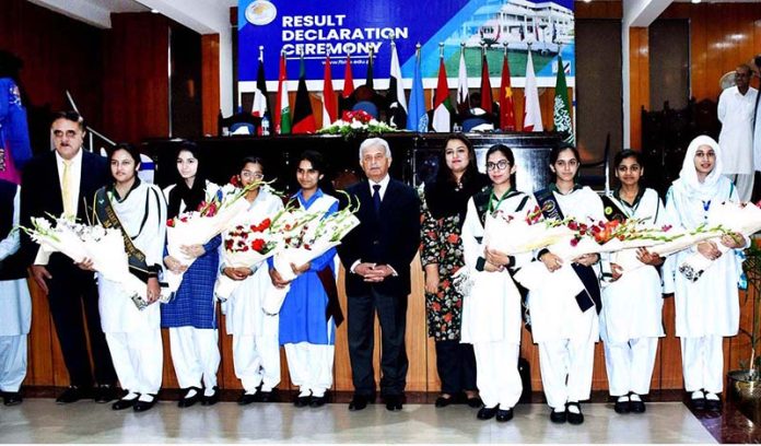 Minister for Federal Education and Professional Training, Rana Tanveer Hussain in a group photograph with the top position holders in the 9th and 10th class annual board examinations
