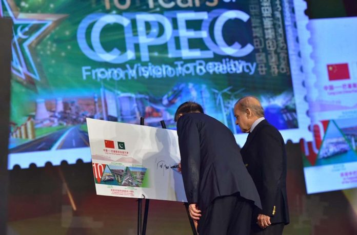 Prime Minister Muhammad Shehbaz Sharif and Chinese President Special Representative and Vice Premier of China Mr. He Lifeng signing the First Day Cover of a commemorative postal stamp at ceremony to celebrate the 10th anniversary of CPEC