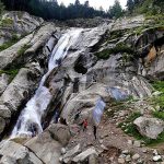 Visitors enjoying the beautiful view of water fall in Kumrat Valley.