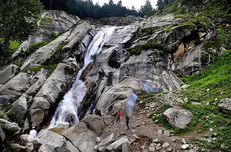 Visitors enjoying the beautiful view of water fall in Kumrat Valley.