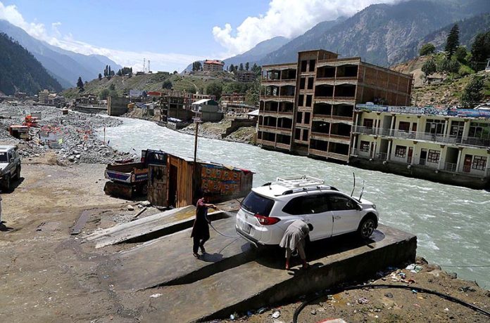 A local person washing the vehicle near Swat river