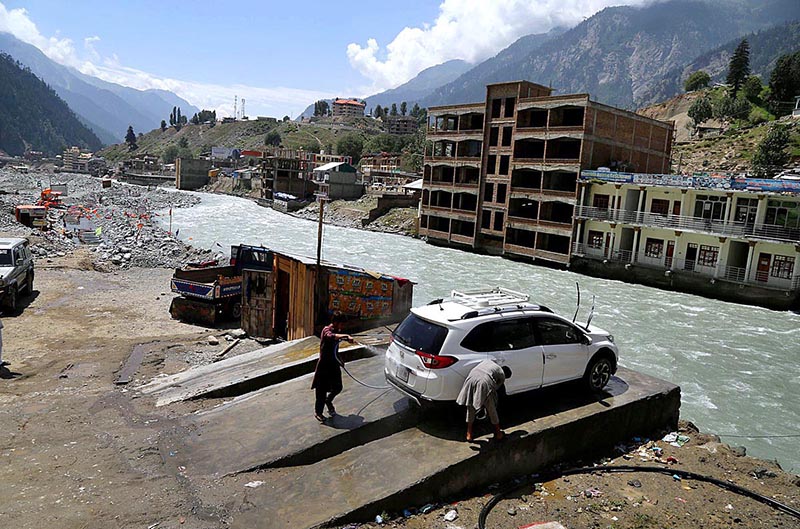 A local person washing the vehicle near Swat river