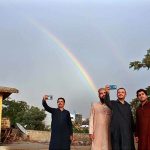 People taking selfie with rainbow as the city receives rain turned weather pleasant