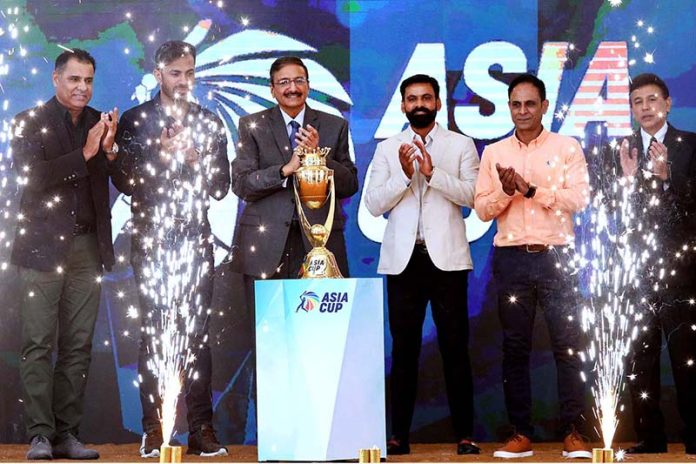 Chairman of the Pakistan Cricket Board Zaka Ashraf with Pakistan's cricketer Wahab Riaz and cricket coach Waqar Younis unveil the Asia Cup 2023 trophy during a ceremony