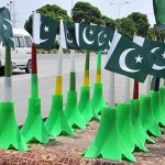 Vendors displaying national flag and other stuff at roadside in connection with upcoming Independence Day celebrations