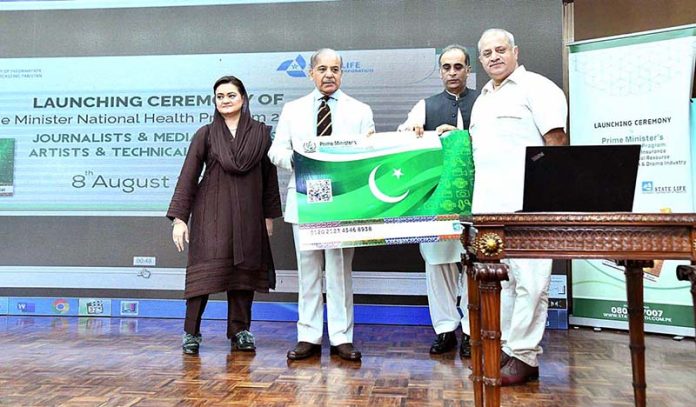 Prime Minister Muhammad Shehbaz Sharif distributing health insurance cards among the working journalists, media workers, artists and technical resource workers