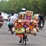 A vendor selling handmade items on his bicycle in the Federal Capital