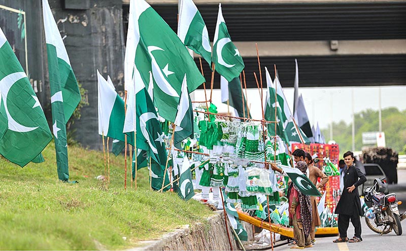Vendors displaying National flags along Islamabad Expressway to attract the customers as the nation starts preparations to celebrate Independence Day in befitting manners