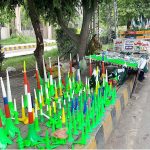 A vendor displaying national flags and other stuffs related to Independence Day celebrations on Murree Road