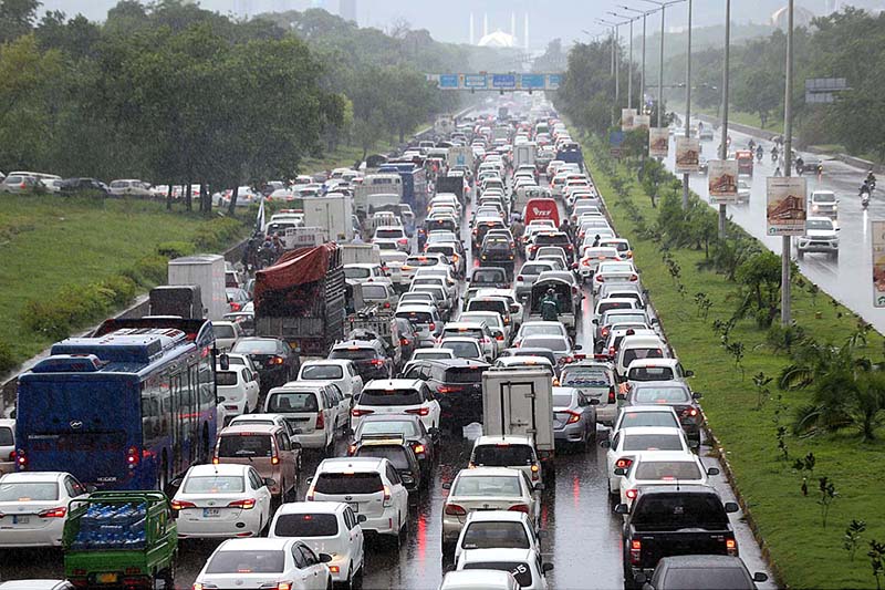 A view of massive traffic jam at Islamabad Expressway during rain that experienced the Federal Capital