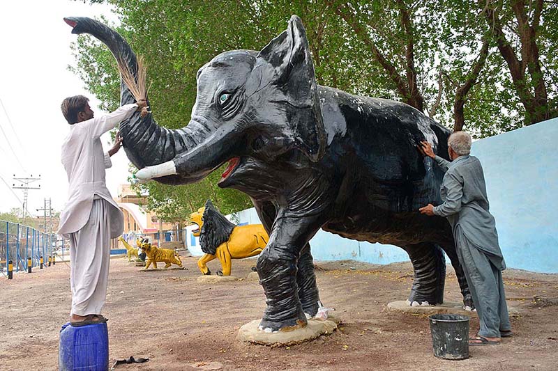 HMC workers busy in cleaning the replica of elephant at local park